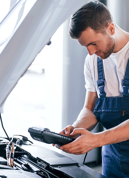 Mechanic using diagnostic tool car